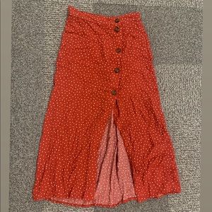Red skirt with white polkadots .